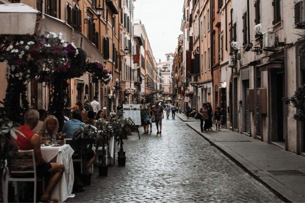 Large family enjoying a shared meal at a traditional restaurant while dining in Rome