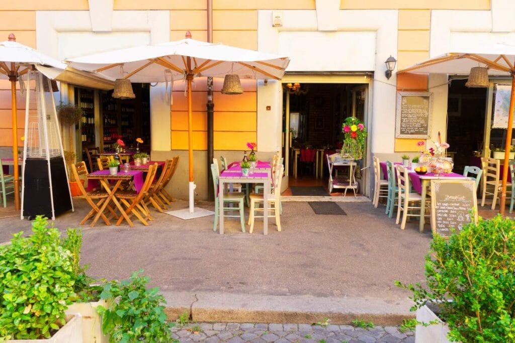 Colorful outdoor tables and umbrellas at a traditional Roman trattoria