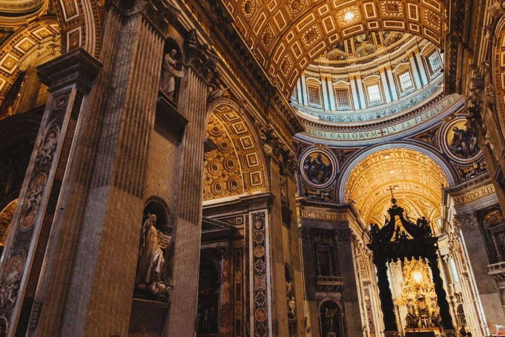 Interior view of St. Peter's Basilica showing the massive golden dome and ceiling for visiting families.