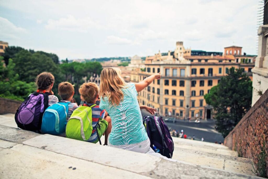 Family resting on steps during a Rome sightseeing tour